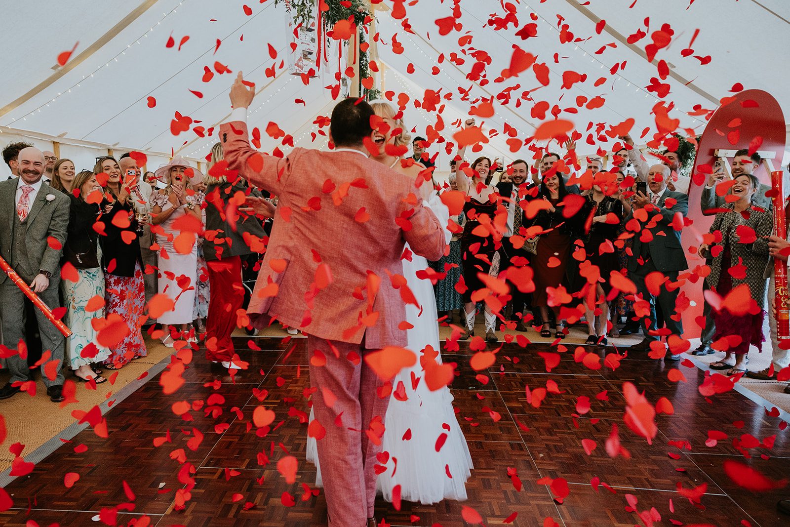 Barney and Ellie sharing their first dance beneath heart-shaped confetti
