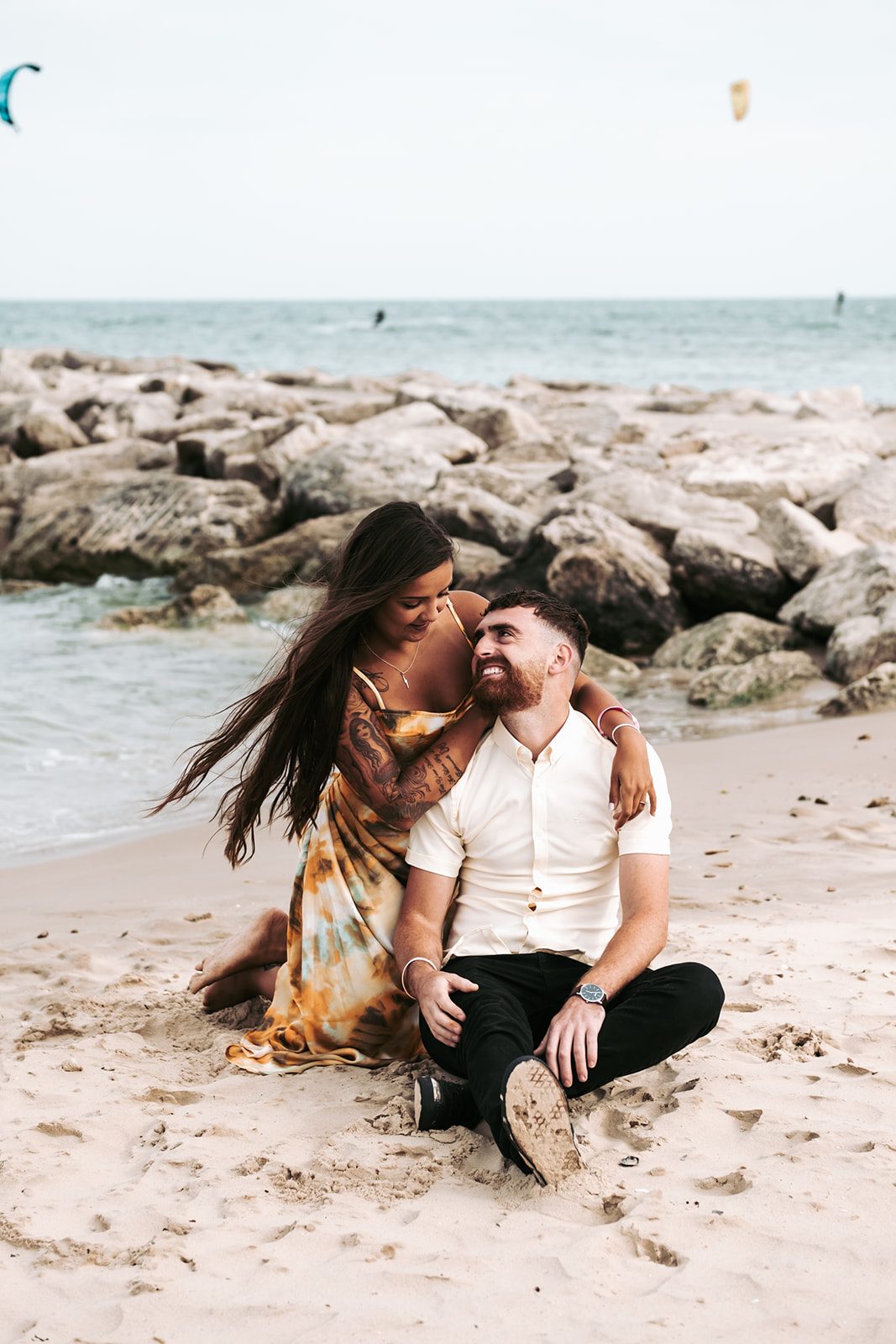 Vikki and Jake smiling together on the beach at Sandbanks