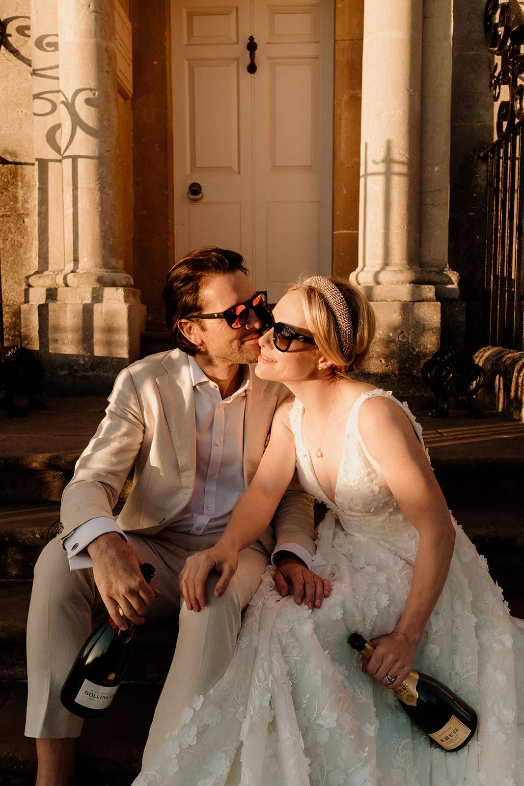 Newlyweds in sunglasses enjoying golden-hour light