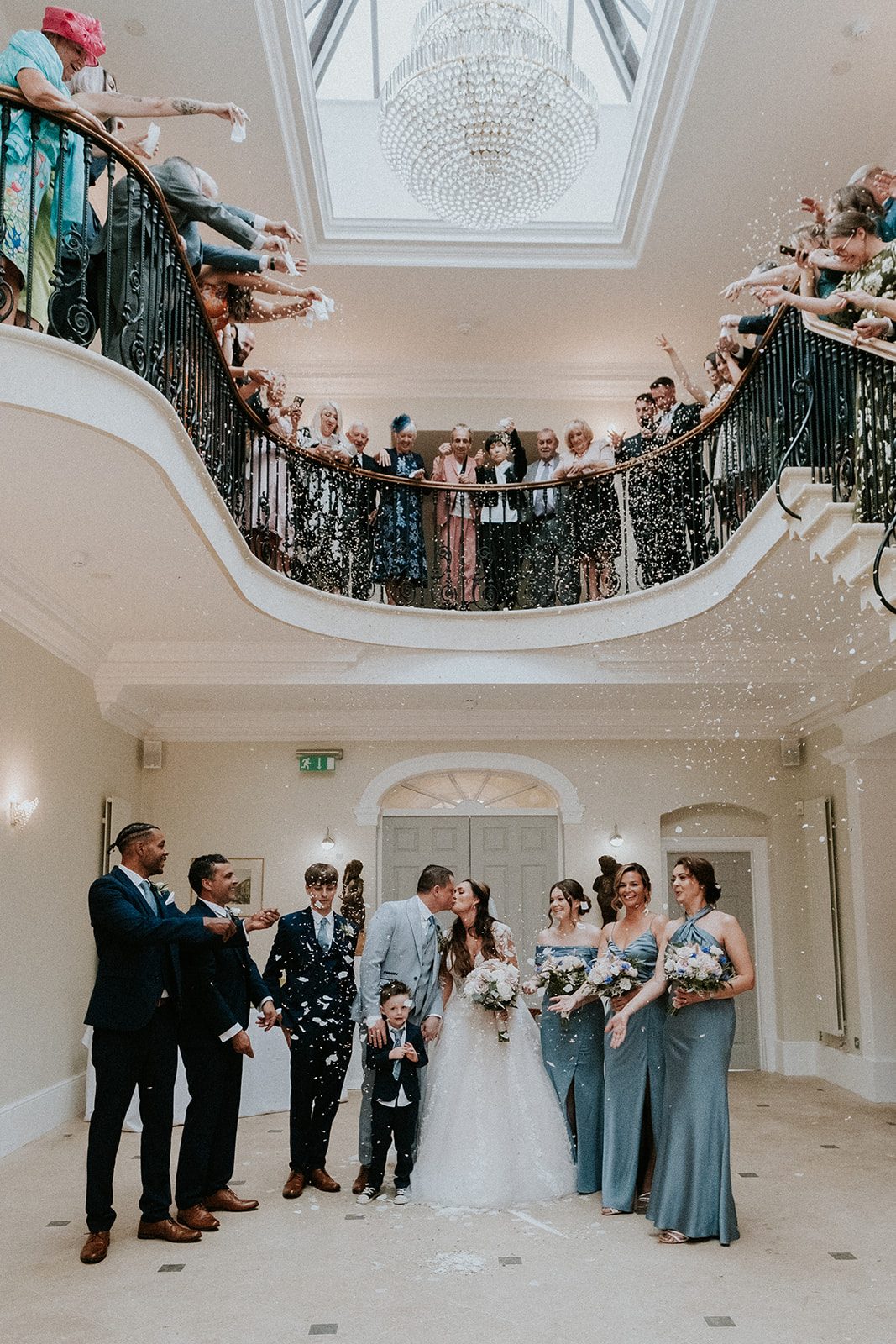 Faye and Wesley kissing beneath a shower of confetti from the balcony at Old Down