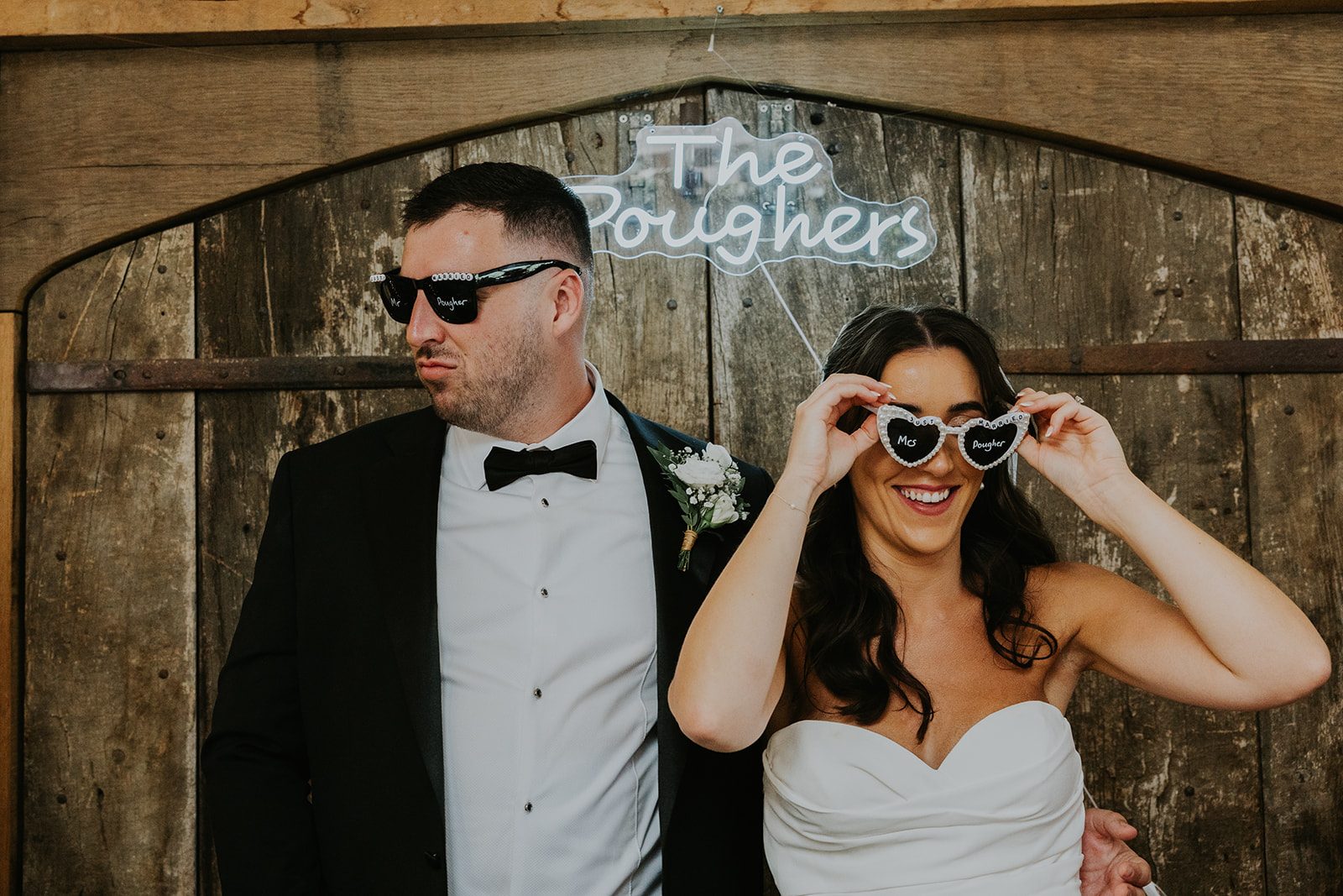 Gemma and Matt having fun in sunglasses, with Gemma wearing heart-shaped glasses
