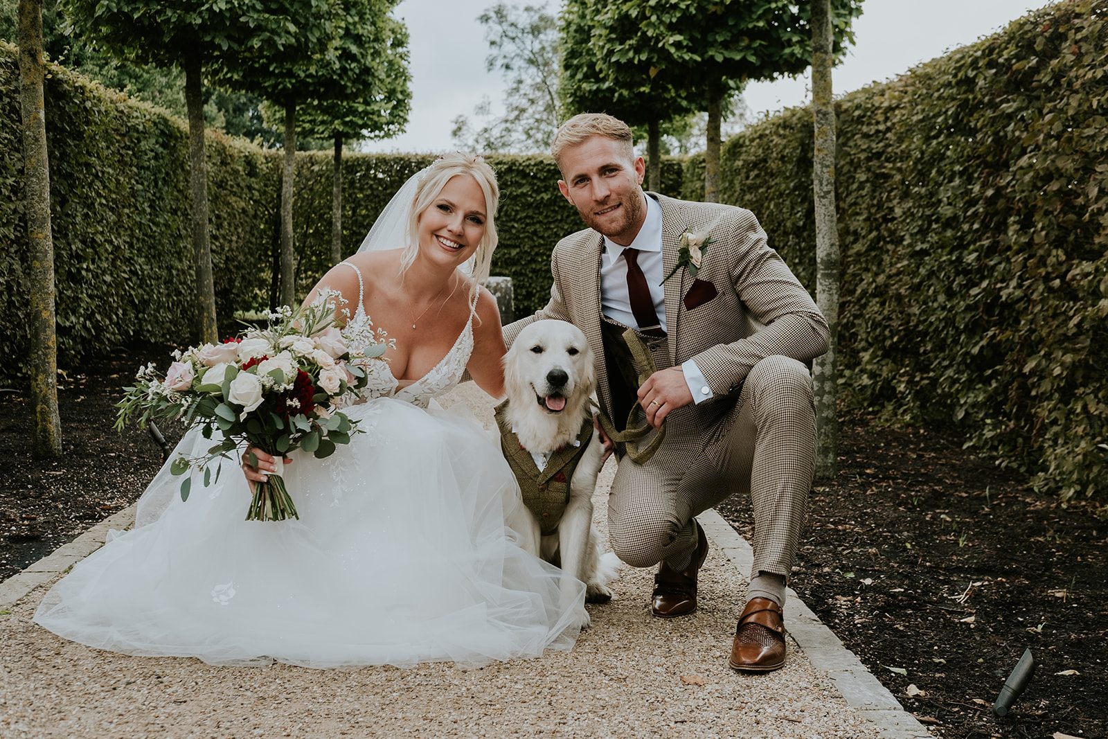 Izzie and Todd with their dog in a matching tweed outfit