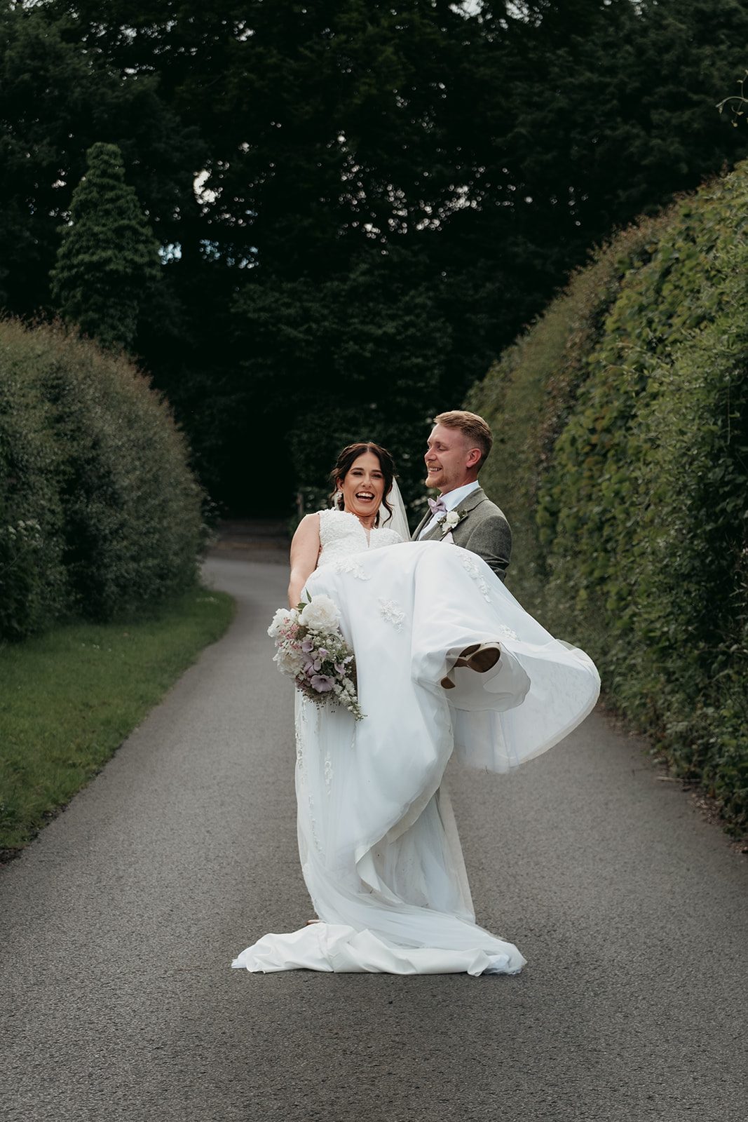 Jade laughing as Zack carries her along the garden path