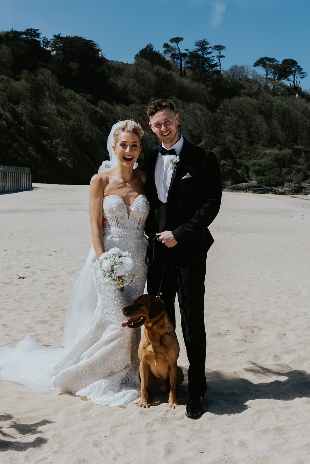 Maisie and Pete with their dog Dougie on the beach at Carbis Bay