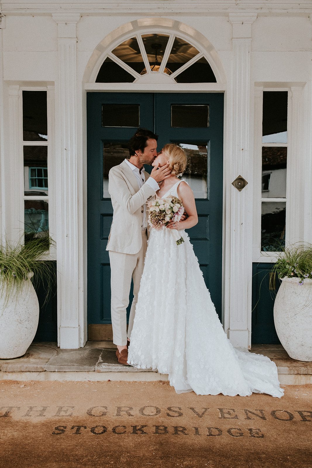 Mel and Justin kissing in the doorway of The Grosvenor Hotel, Stockbridge
