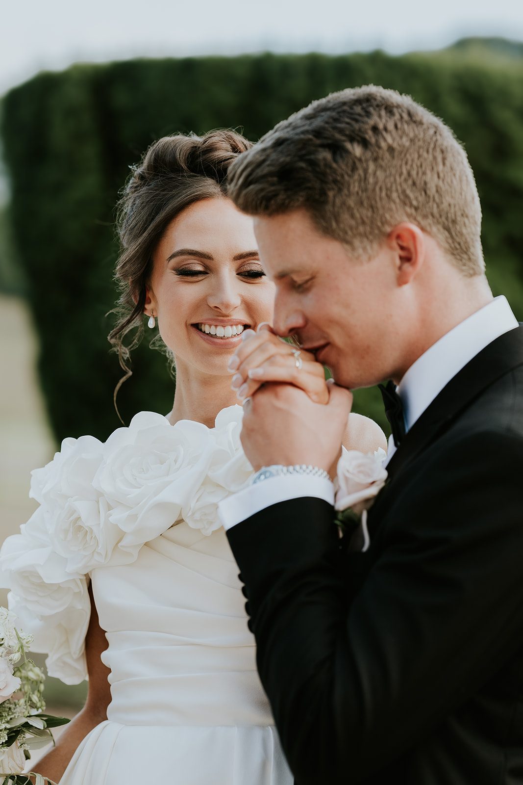 Phoebe smiling as Byron kisses her hand
