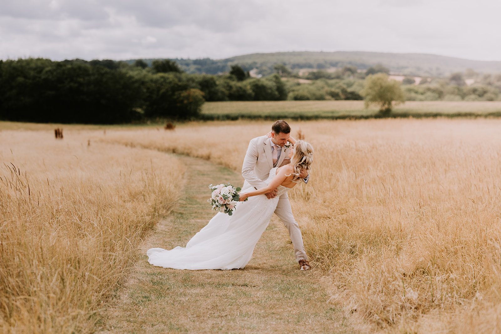 Rosie and Jake sharing a dip kiss in a field