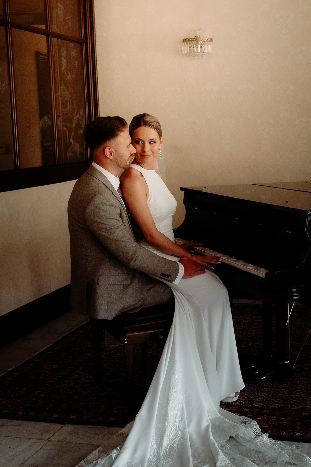 Zoe and Liam sitting together at the piano at Grand Hotel Toplice